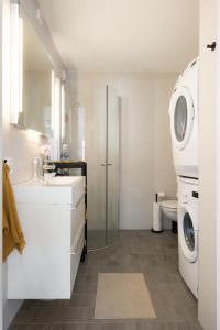 a bathroom with a sink and a washing machine at Central apartement in Kristiansund in Kristiansund +13 photos