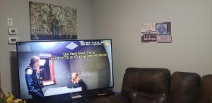 a flat screen tv sitting in a living room at Room to stay in Lethbridge