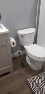 a bathroom with a white toilet and a sink at Room to stay in Lethbridge