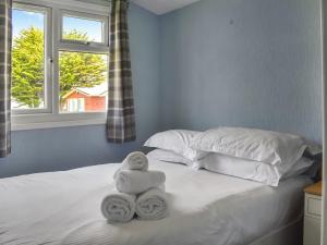 a bedroom with a bed with towels on it at Old Town Cove - Uk47724 in St Merryn