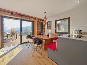 a kitchen with a counter and a table with chairs at Mirador Lodge - Crans Montana - Swiss Alps in Randogne