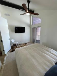 een slaapkamer met een groot bed en een plafondventilator bij Star Valley Barndominium Unit B in Thayne