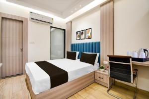 Postel nebo postele na pokoji v ubytování Super Townhouse Bairhana Road Prayagraj