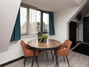 a dining room with a table and two chairs at Luxury apartment in Renesse with infrared sauna in Renesse