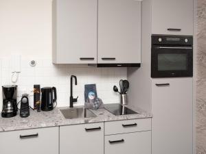 a kitchen counter with a sink and a microwave at Luxury apartment in Renesse with infrared sauna in Renesse