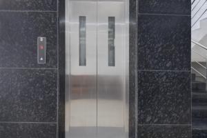 a glass elevator door in a building at Super Townhouse Pimple Nilakh Pune in Dāpuri +22 photos