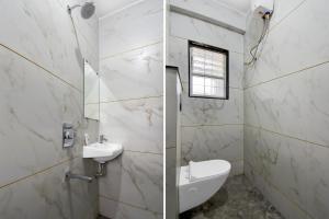 a white bathroom with a sink and a toilet at Super Townhouse Pimple Nilakh Pune in Dāpuri