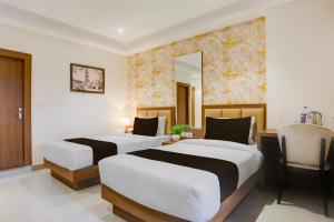 Postel nebo postele na pokoji v ubytování Super Townhouse Oak Sevoke Road Siliguri