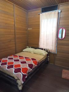 a bed in a room with a window at Villa Kayu Danke in Ciguntur