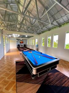 a large room with a pool table in it at Villa Kayu Danke in Ciguntur