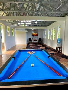 a pool table in the middle of a room at Villa Kayu Danke in Ciguntur