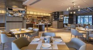 PenshanにあるZhejiang Cloud Mountain Deefly Hotelのテーブルと椅子とバーのあるレストラン