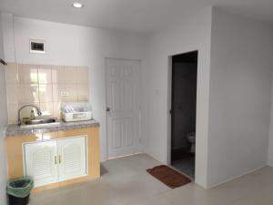 a kitchen with a sink and a toilet in a room at Bangtao Mango House in Bang Tao Beach