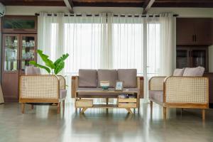 a living room with two chairs and a couch at Penthouse by Grit Villas - Penthouse Apartment with a Private Pool in Negombo