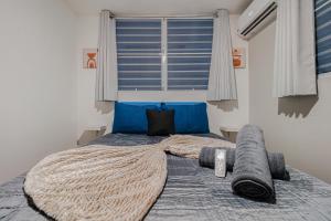 a bedroom with a bed with a large window at Beach Side House Amazing For Family and Group by PH in Luquillo +22 photos