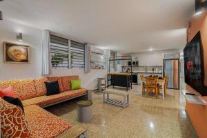 a living room with a couch and a kitchen at Beach Side House Amazing For Family and Group by PH in Luquillo