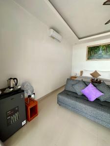 a living room with a couch and a table at Dewata Beach House in Amed