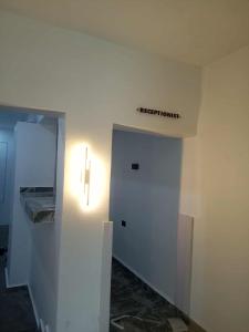 una stanza d'ospedale con una porta e una croce sul muro di Divine Villa and Resort Guest House PLOT 35 Umuezeukwu Road, Oboro, Ikwuano LGA,Abia State 