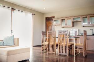 a living room with a kitchen with a table and chairs at Penthouse by Grit Villas - Penthouse Apartment with a Private Pool in Negombo +23 photos