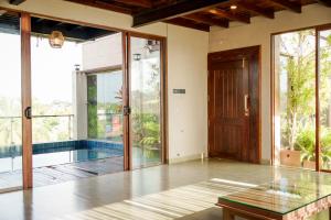 an empty room with a pool and a glass table at Penthouse by Grit Villas - Penthouse Apartment with a Private Pool in Negombo