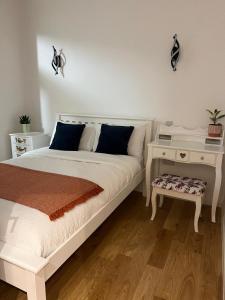 a bedroom with a white bed and a night stand at New Two Bedroom Suite - With Terrace in London