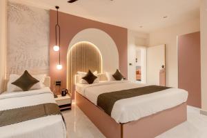 a bedroom with two beds and a large window at Legacy Inn, Mysore in Mysore +60 photos