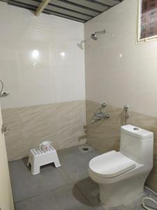 a bathroom with a toilet and a shower at Anjanadri Lakeview Gardens - Sapthashree Nivasa in Hosūr