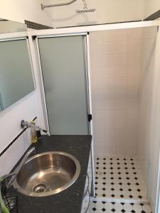 a small bathroom with a sink and a shower at Self Contained Cabin in Nildottie