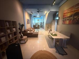 a living room with a table and a couch at Alura Hostel in Kata Beach