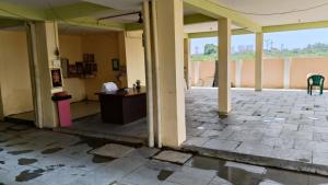 an empty room with a table and chairs in a building at GM nest in Coimbatore