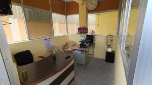 an office with a desk and a clock on the wall at GM nest in Coimbatore