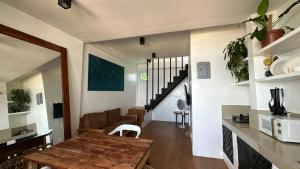 a living room with a wooden table and a dining room at Two Bedroom Beachfront Penthouse in Boracay