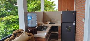 a kitchen with a counter with a blender and a stove at Amed Sari Beach Guesthouse in Amed