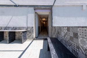 a hallway of a building with a window and a bench at Legacy Inn, Mysore in Mysore