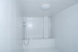 a white bathroom with a shower with a ceiling at Perfecta Suite En Samborondon Plaza in Guayaquil +27 photos