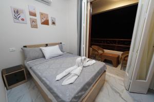 a bedroom with a bed with a towel on it at maravilla downtown cairo in Cairo