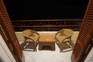 three chairs and a table on a balcony at maravilla downtown cairo in Cairo