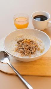 a bowl of cereal and a cup of coffee on a table at Curve Boutique Hotel in Pattaya Central