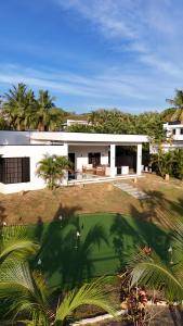 an aerial view of a white house with a yard at Heaven Retreat with Minigolf, pool, fire pit, BBQ in Nadi