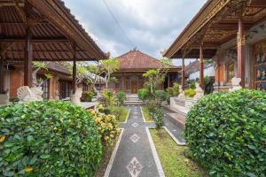 a building with a pathway in front of a building at Jiwandari House Bali in Darmasaba