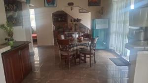 a kitchen and dining room with a table and chairs at St Michael View in Moratuwa