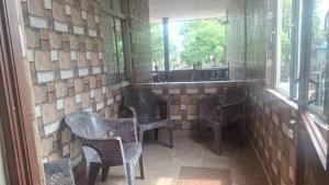 a room with chairs and tables and windows at St Michael View in Moratuwa