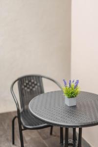 a black table and chair with a potted plant on it at Jiwandari House Bali in Darmasaba +36 photos