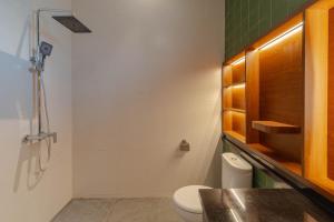a bathroom with a toilet and a sink at Jiwandari House Bali in Darmasaba