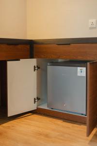 a door in a cabinet with a television in it at Jiwandari House Bali in Darmasaba