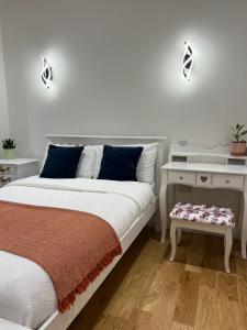 a white bedroom with a bed and a table at New Two Bedroom Suite - With Terrace in London