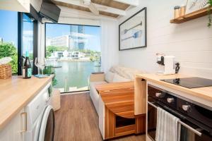 a tiny house with a kitchen with a view of the water at Tiny Home in the heart of Broadbeach-River Views! in Gold Coast