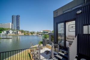 a black house with a view of a river at Tiny Home in the heart of Broadbeach-River Views! in Gold Coast