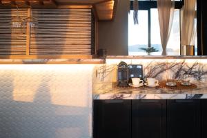 a kitchen with a counter with a coffee maker on it at Vivere Azure in Batangas City +103 photos