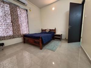 a bedroom with a bed and a large window at VINTAGE VISTA RESORTs in Chennai +38 photos